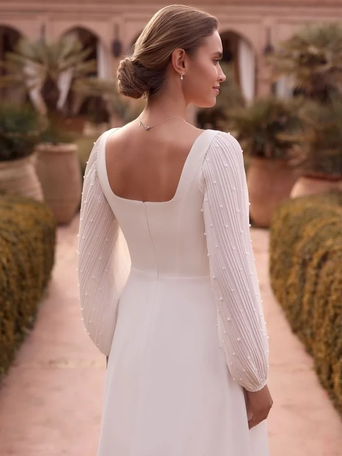 lumi sleeve side view showing delicate micro pleat and pearl details