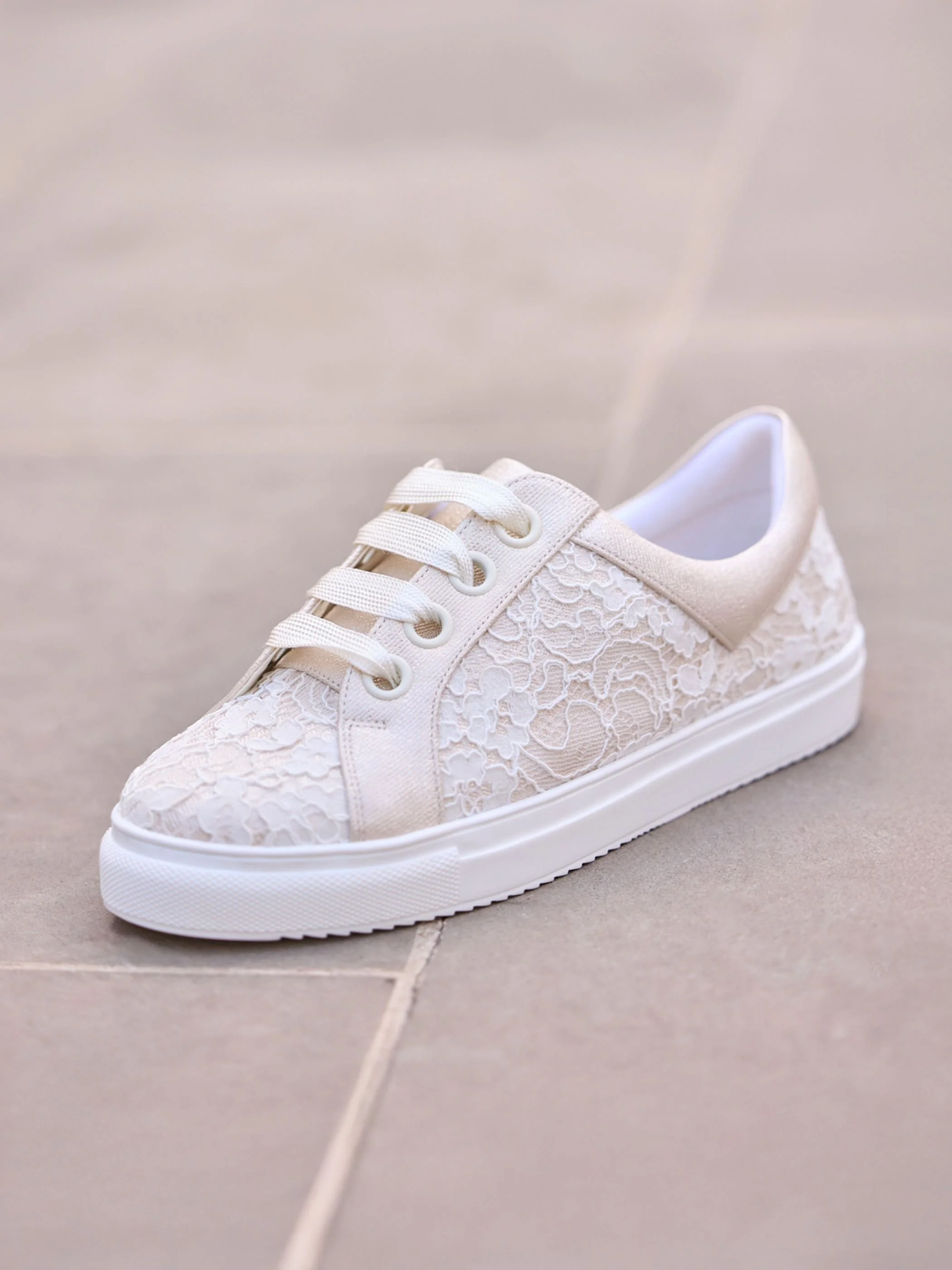 Pako side blank background Pako Ivory and gold bridal sneaker with lace detail