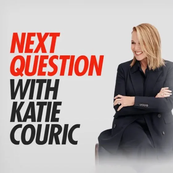 A woman with blonde hair wearing a black blazer sitting with her arms crossed, smiling. The background features a light gray color with bold red and black text that reads 'Next Question with Katie Couric'.