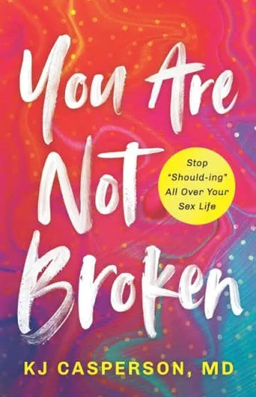 Book cover titled 'You Are Not Broken' by KJ Caperon, MD, with a colorful, swirling background and a yellow circle with the text 'Stop