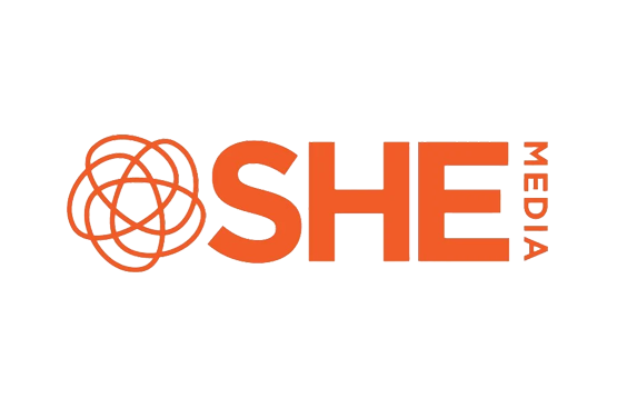 SHE Media logo with an abstract orange globe design on the left and bold orange text reading 'SHE MEDIA' on a black background.