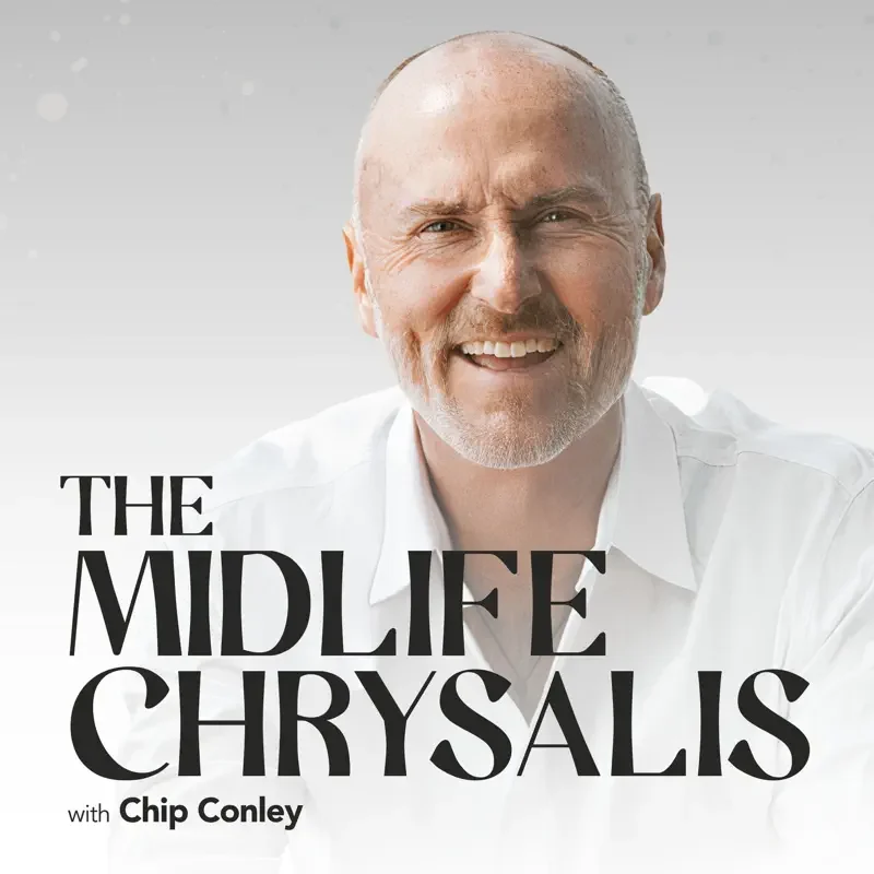 Close-up of a smiling man with a bald head and gray beard, wearing a white shirt, against a light background. Text overlay: "The Midlife Chrysalis with Chip Conley."