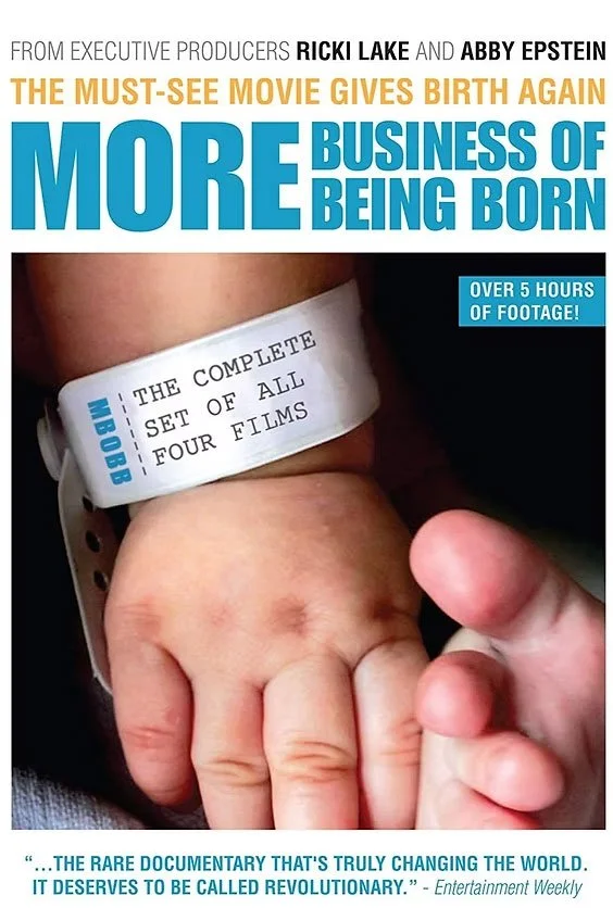 Close-up of a person's wrist with a film festival bracelet and a baby's hand clasped.