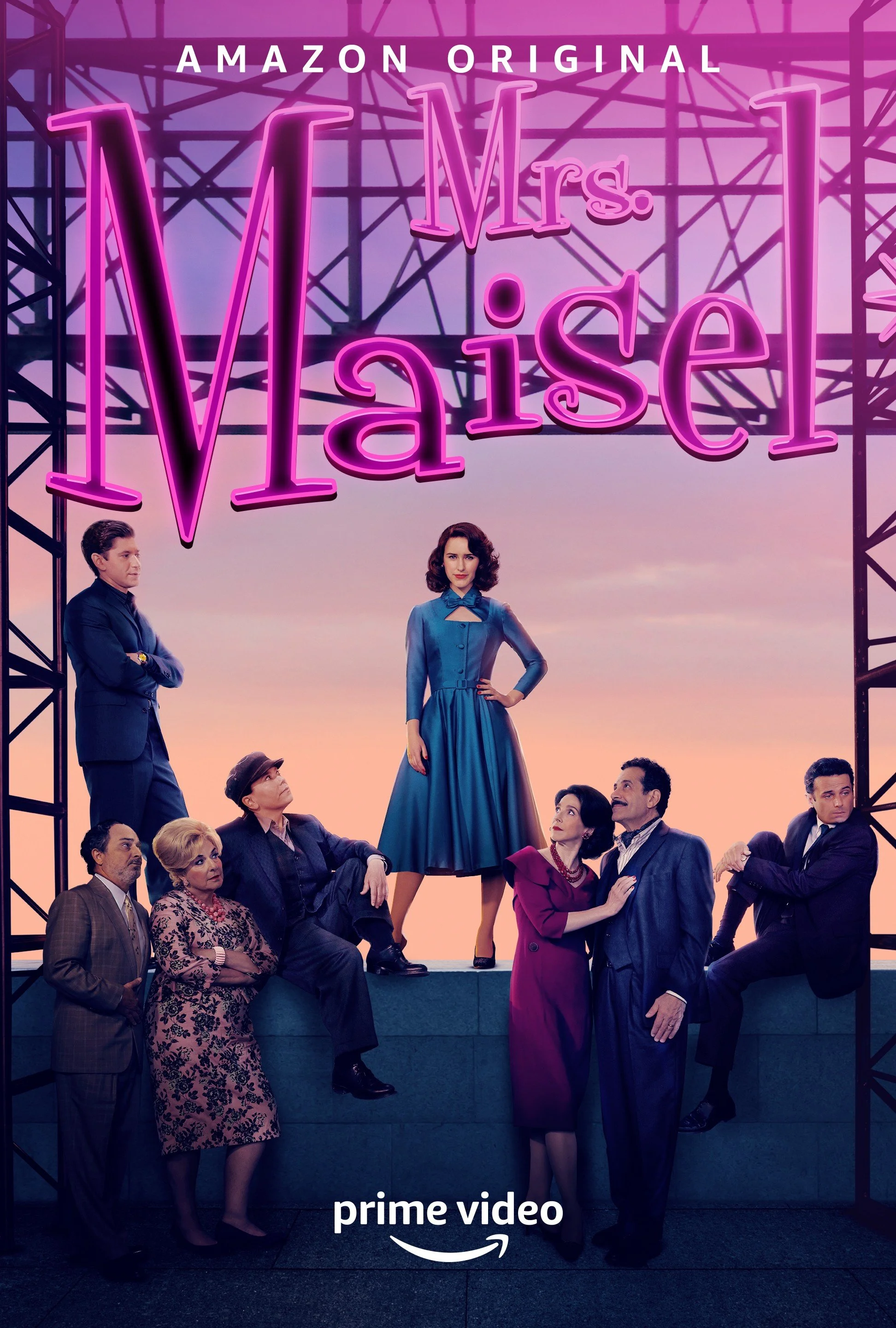 A group of people dressed in vintage clothing posing outdoors at sunset, with a neon sign reading 'Mrs. Maisel' and 'Amazon Original' above them, and a 'prime video' logo at the bottom.