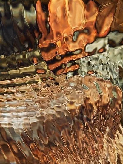 Abstract reflection of metallic, copper, and bronze colors in water.