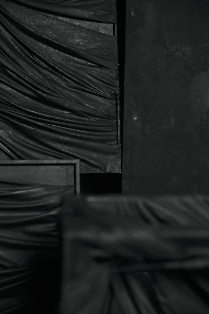 A collection of dark, sculptural and textural paintings.