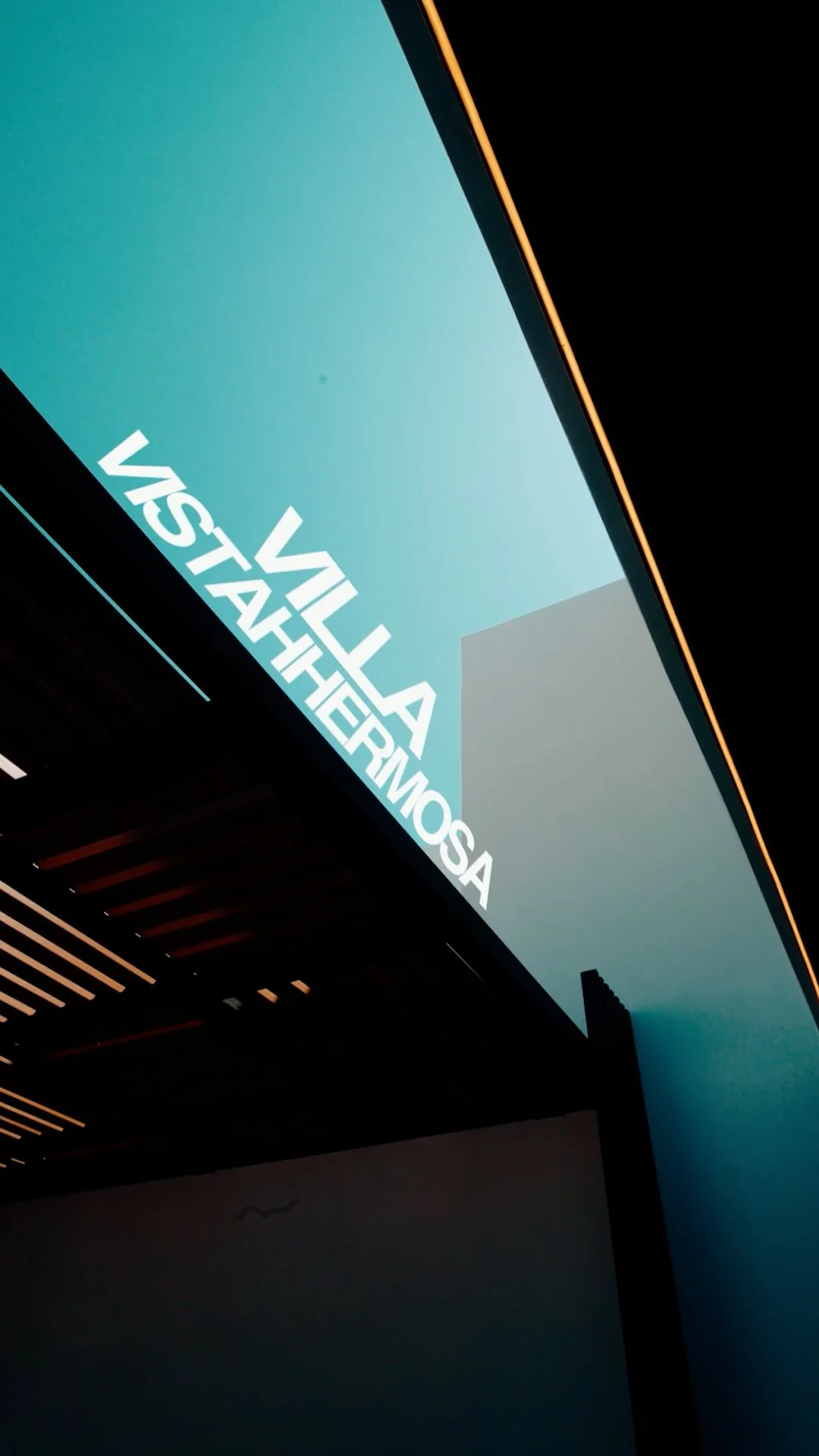 Sign that reads 'Villa VistaHermosa' with a modern design and lighting.