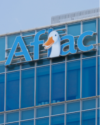 The Aflac logo on a building with a duck illustration replacing the letter 'l' in 'Aflac'.