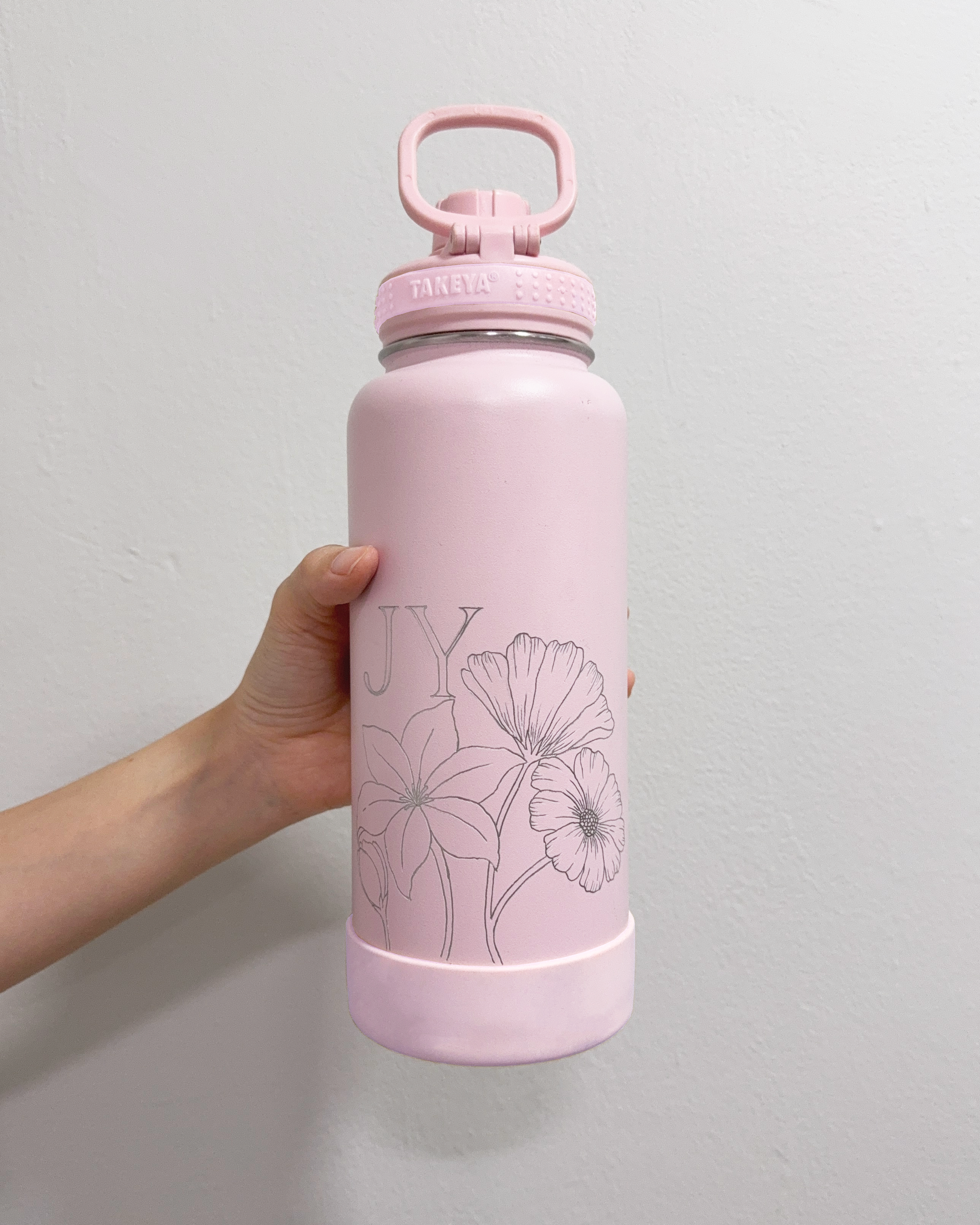 Hand Engraved Personalised Initials on Takeya Insulated Bottle, with Custom Floral Illustration. Tool used: Hand Engraver.
