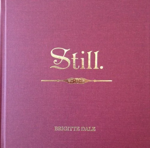 The cover of a book titled 'Still.' by Brigitte Dale in gold lettering on a purple background.