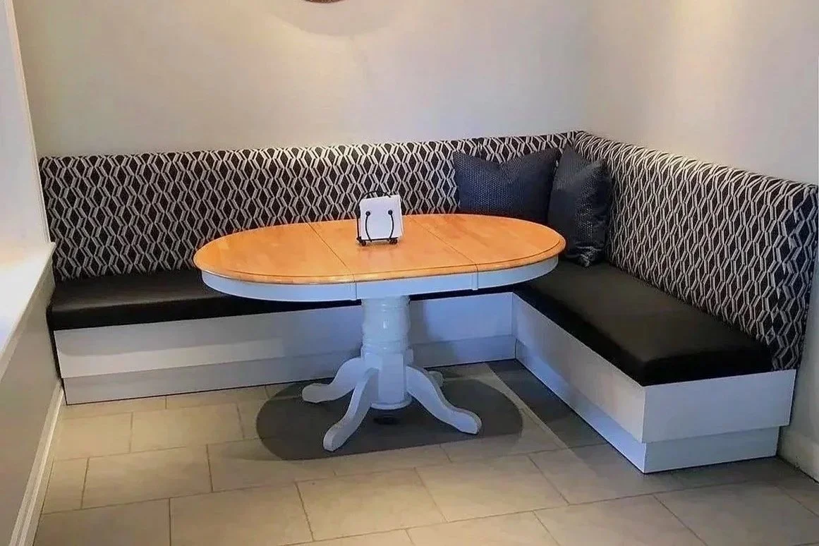 Custom upholstered corner booth with wood table