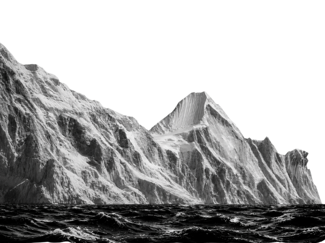 Black and white photo of rugged icy mountains above rough ocean waves.