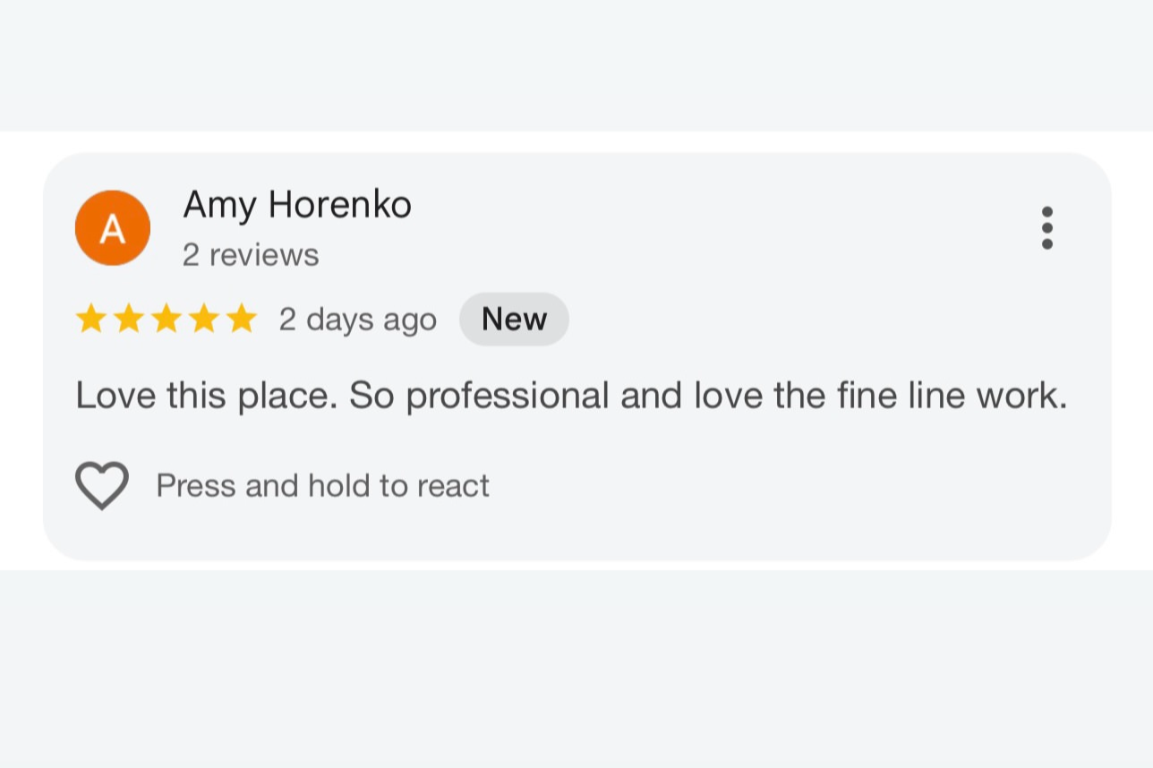 Screenshot of a Yelp review for Amy Horenko, with a five-star rating, posted two days ago, stating love for the place's professionalism and fine line work.