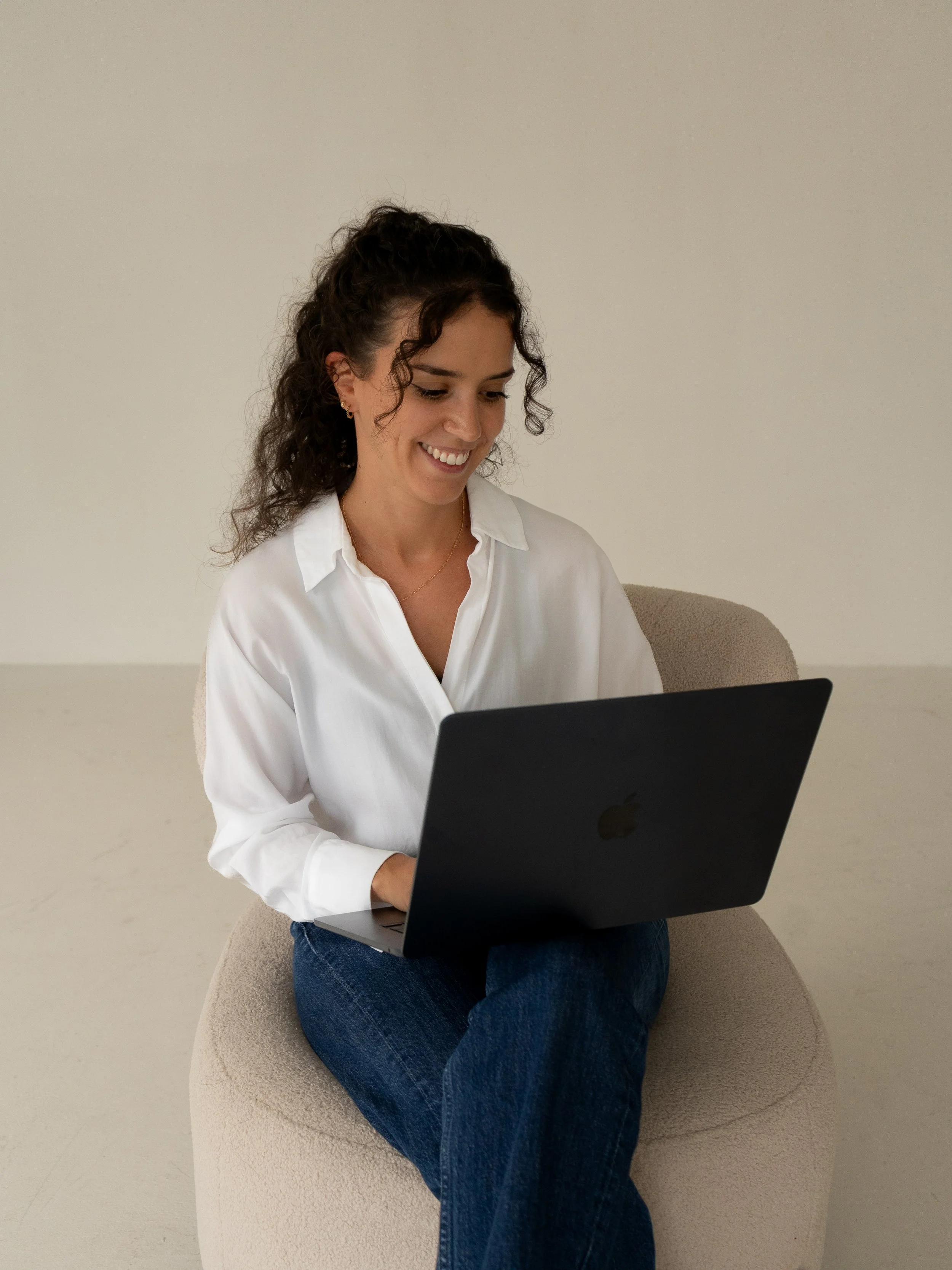 femme souriante en appel visio avec un client sur son laptop