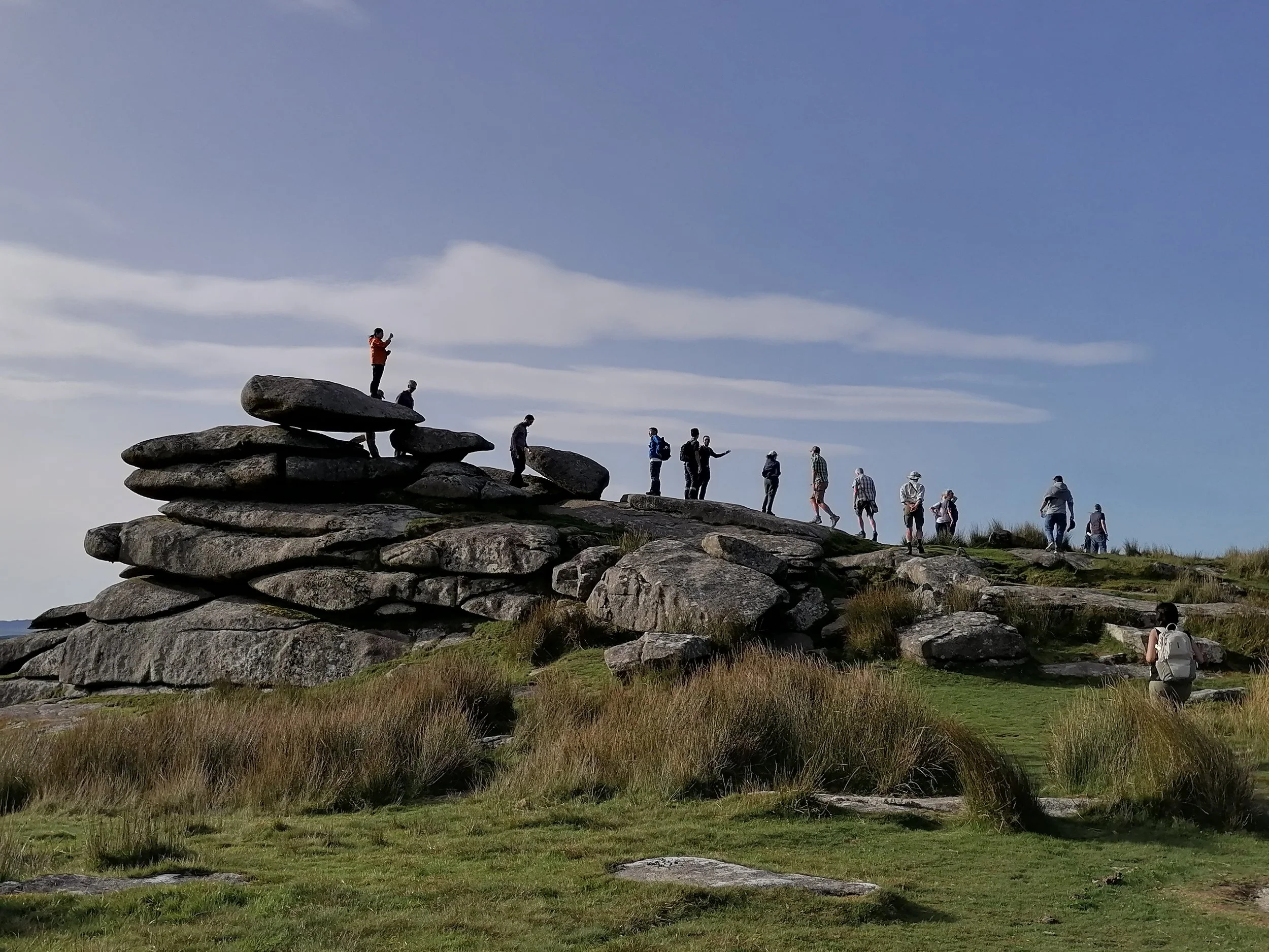Group of people hiking on Stowe's Hill looking at the archaeology and geology.