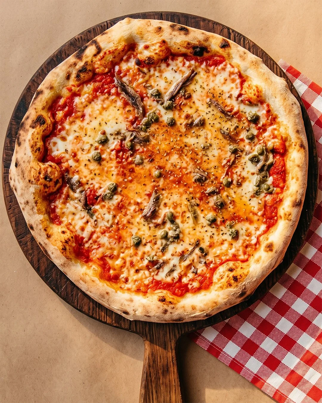 Pizza garnie d'un œuf, de câpres et d'anchois, pizzeria Bellucci à Yverdon-les-Bains
