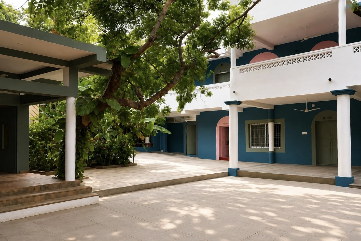 Outdoor courtyard at Satya Aspire Center surrounded by greenery