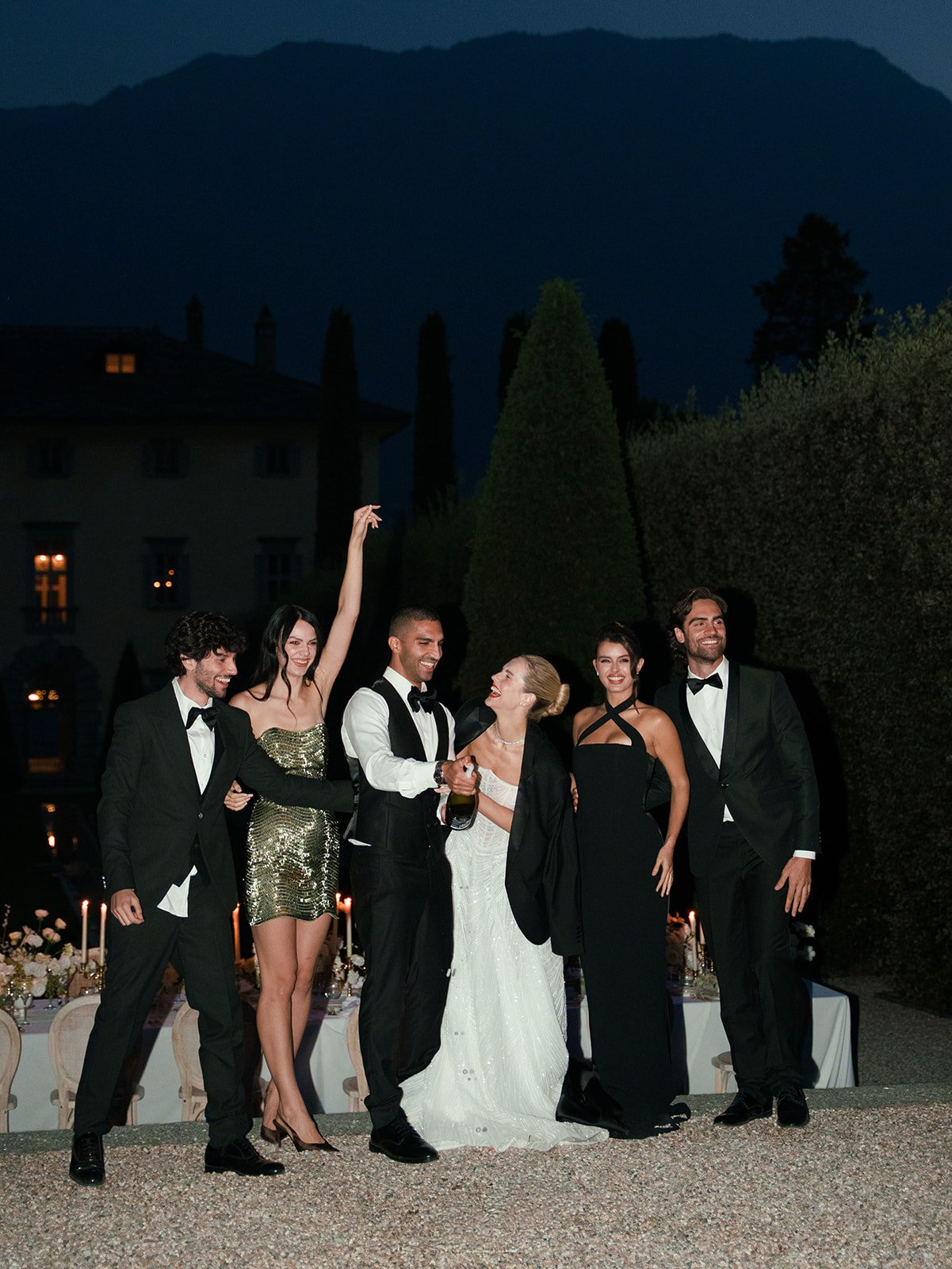 Bride, groom and wedding party celebrating after dinner at Villa Balbiano on Lake Como.