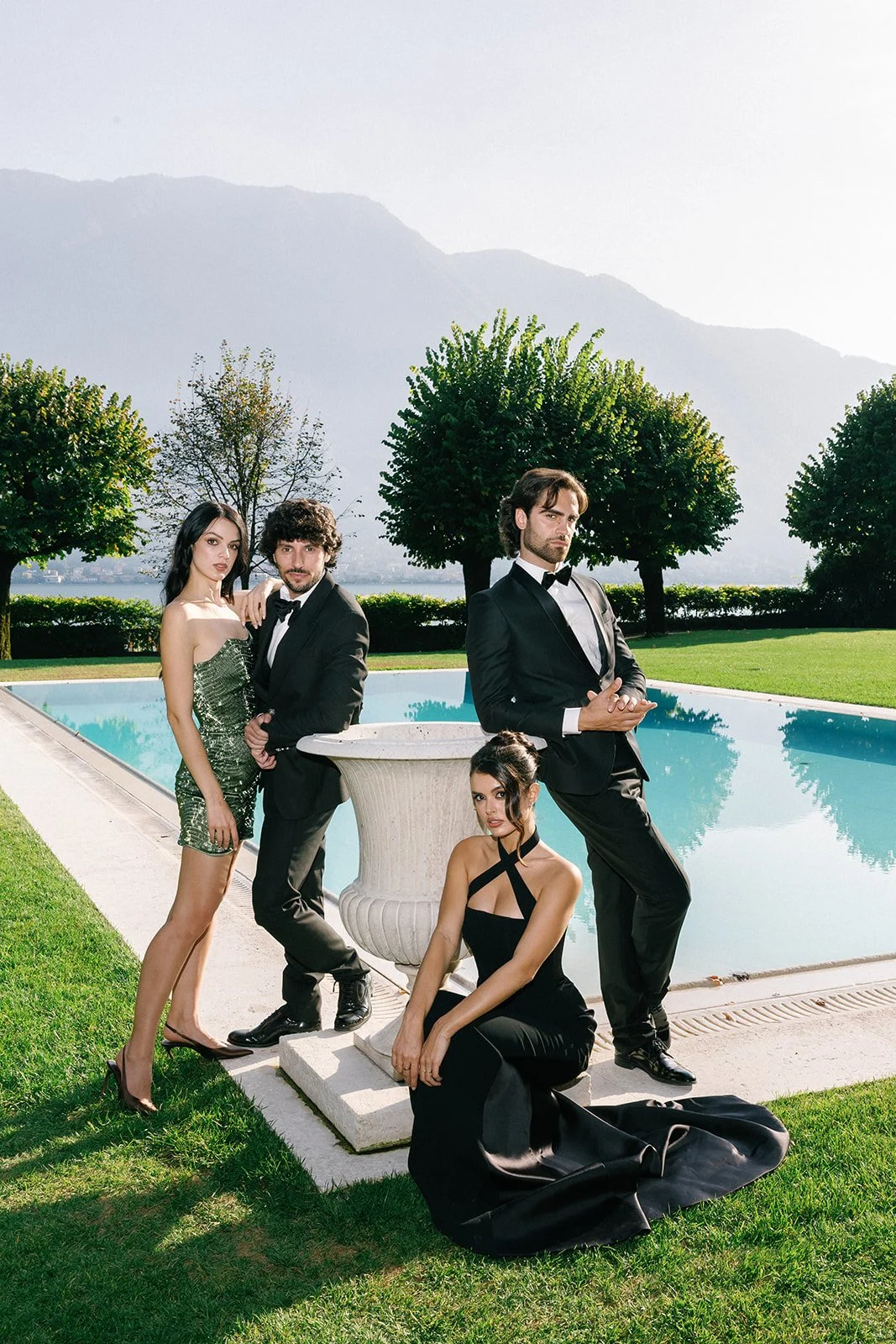 Bride, groom and wedding party posing beside the pool at Villa Balbiano in Lake como.