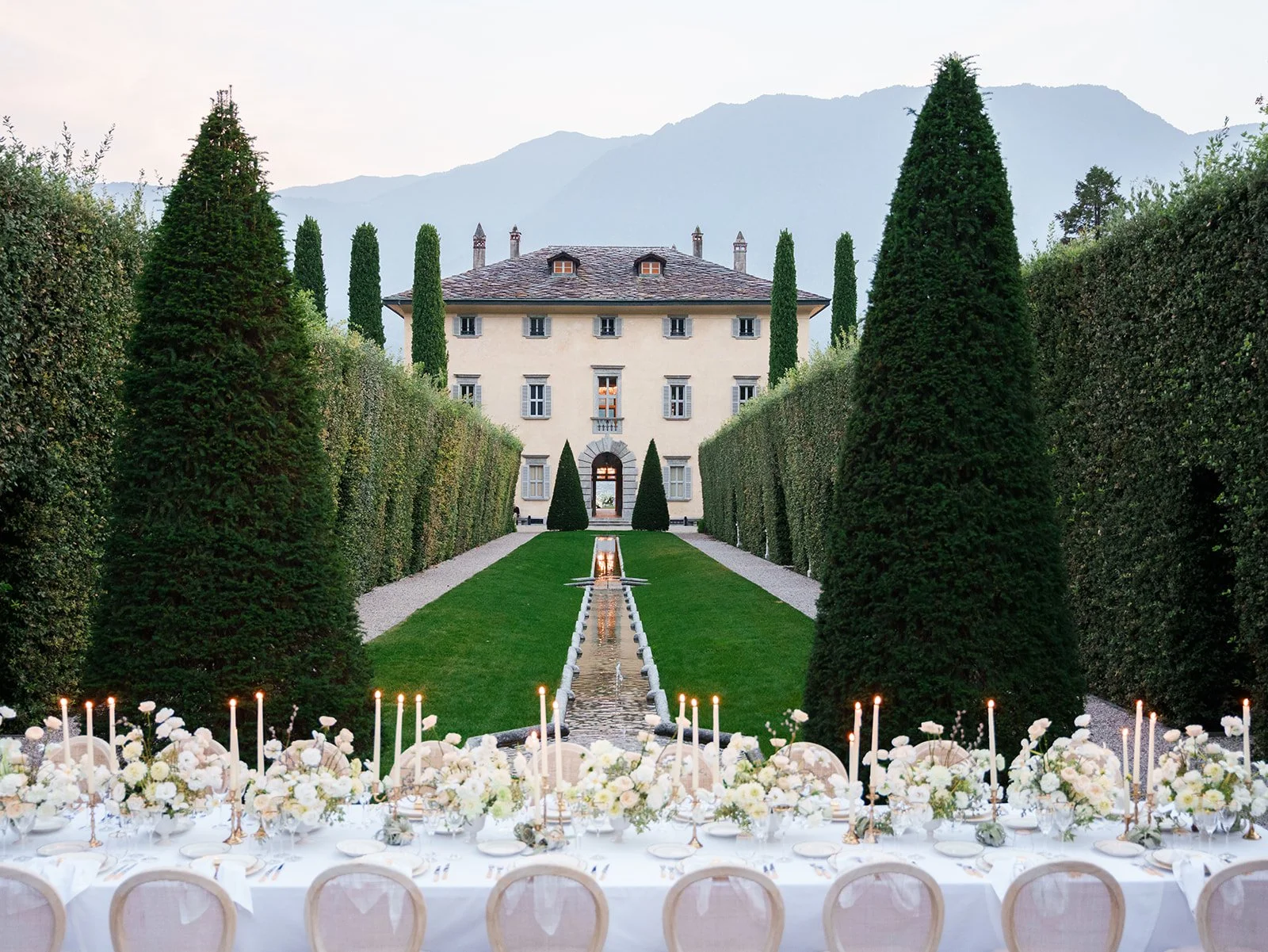 wedding table with floral arrangements in front of villa balbiano 