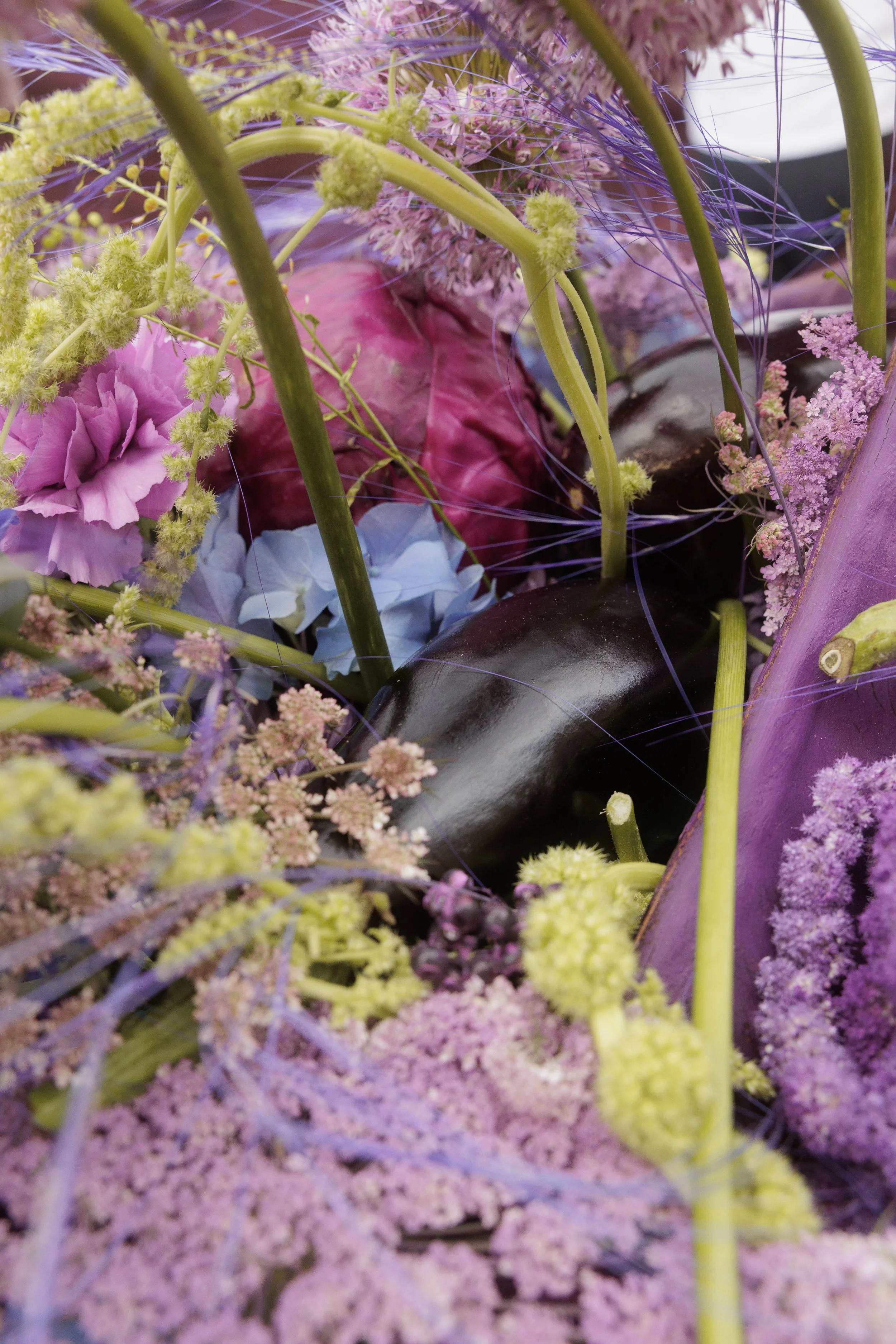 Close-up of bold wedding flowers in cobalt blue, violet, pink and chartreuse green.