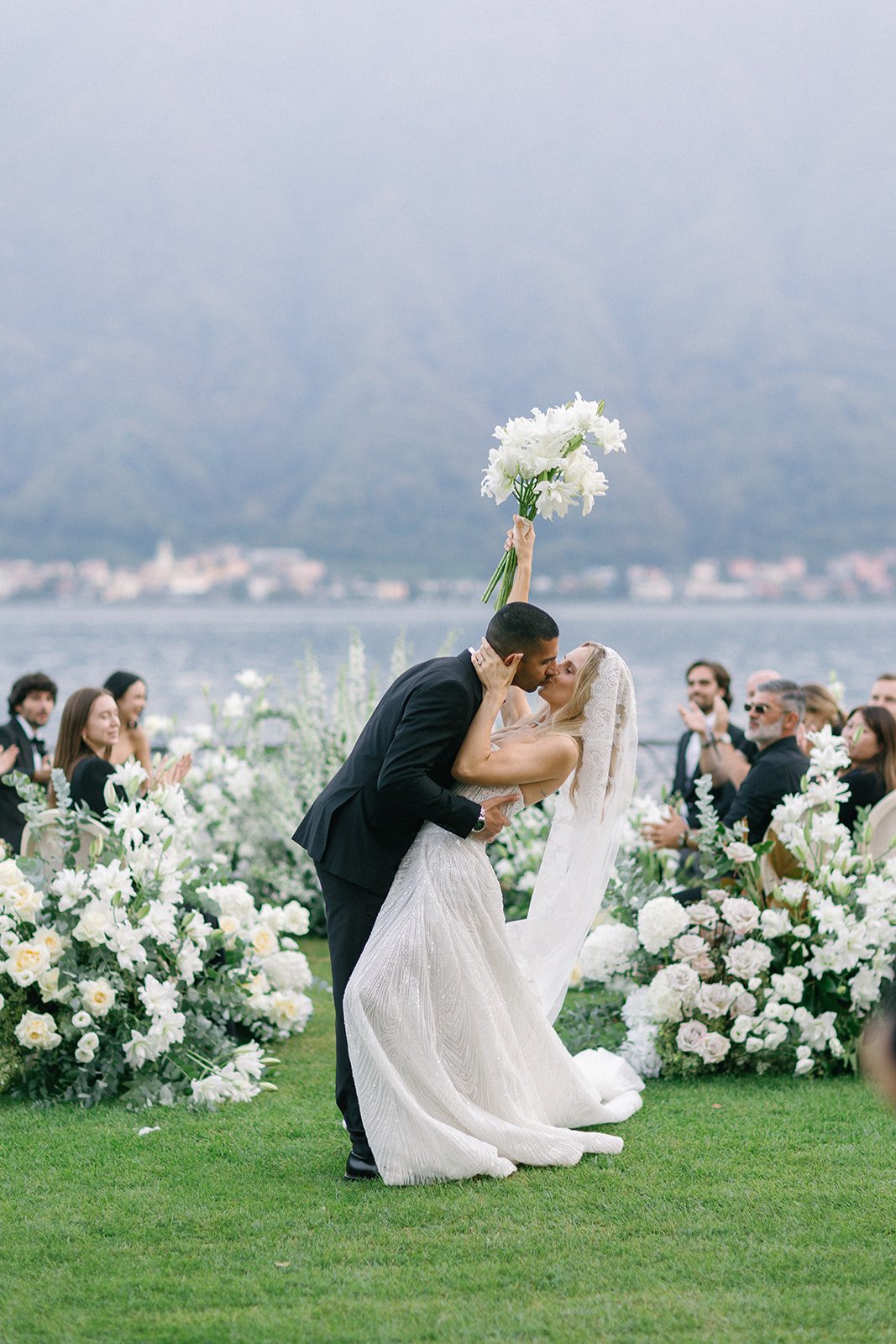 Bride and groom sharing their first kiss during a wedding editorial at Villa Balbiano.