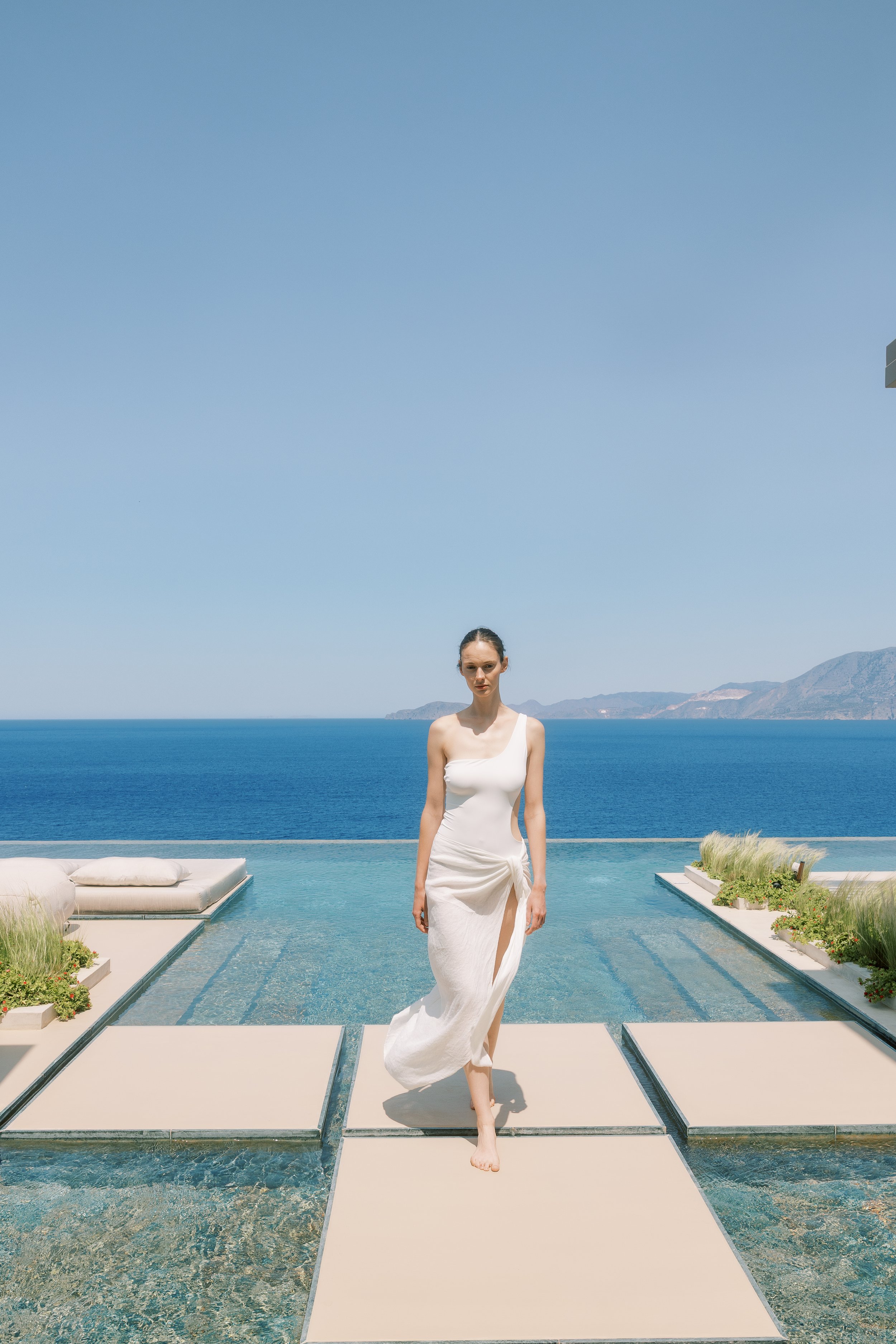 Modern bride overlooking the sea at a private wedding estate in Crete.