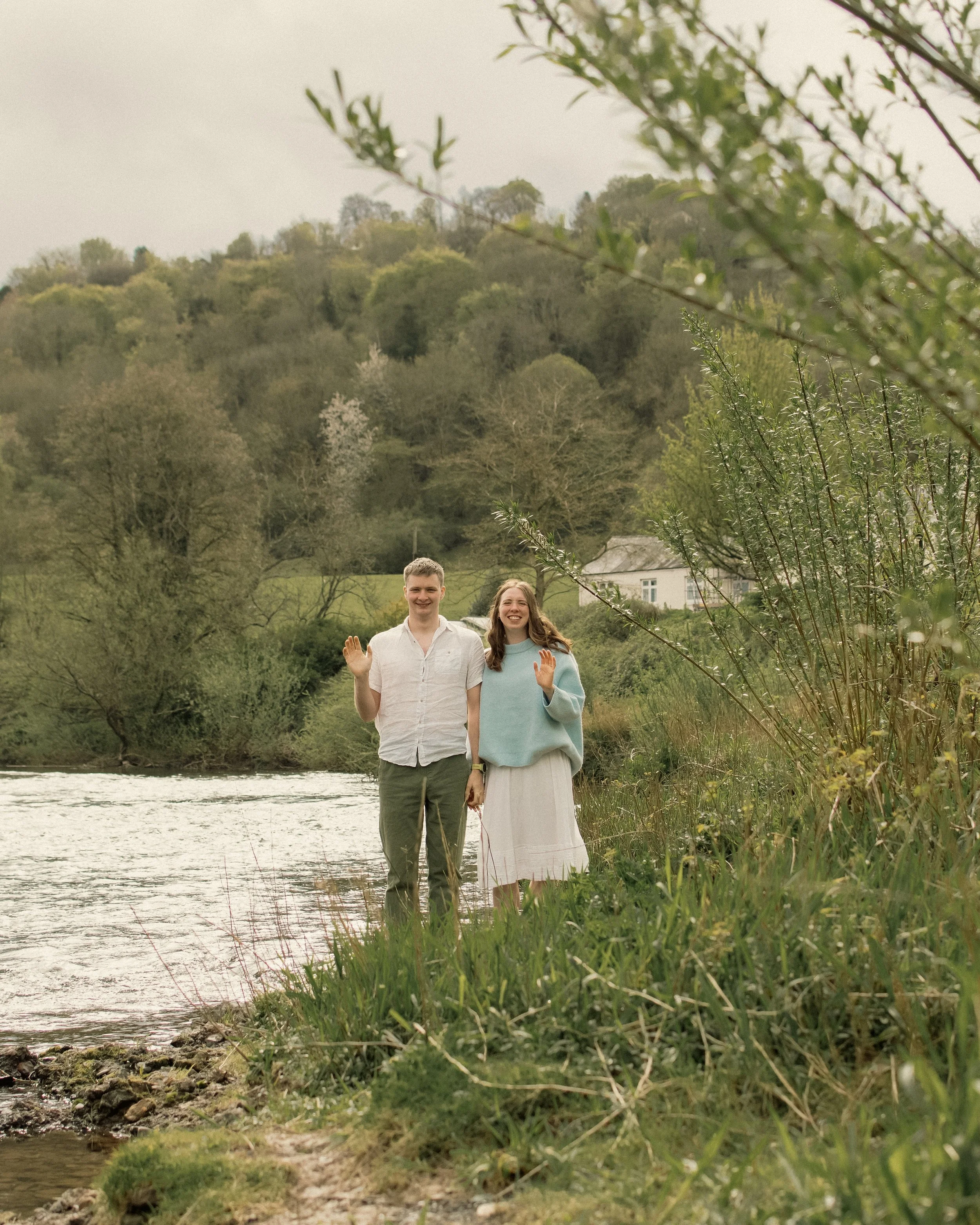 documentary candid wes anderson style engagement photography countryside river.jpg