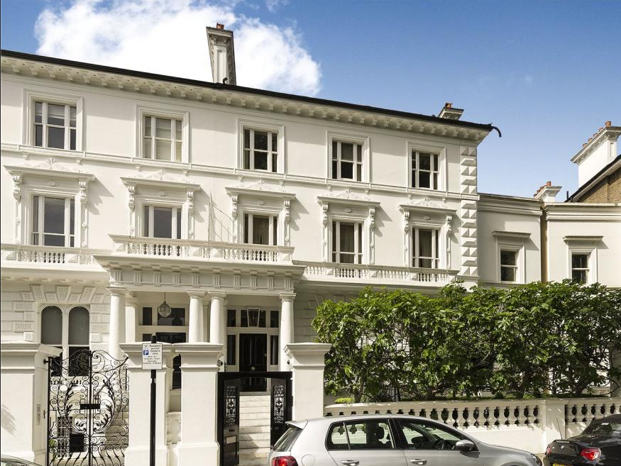 A white multi-story Victorian property development in Holland Park, Kensington, with decorative columns and detailed moldings.
