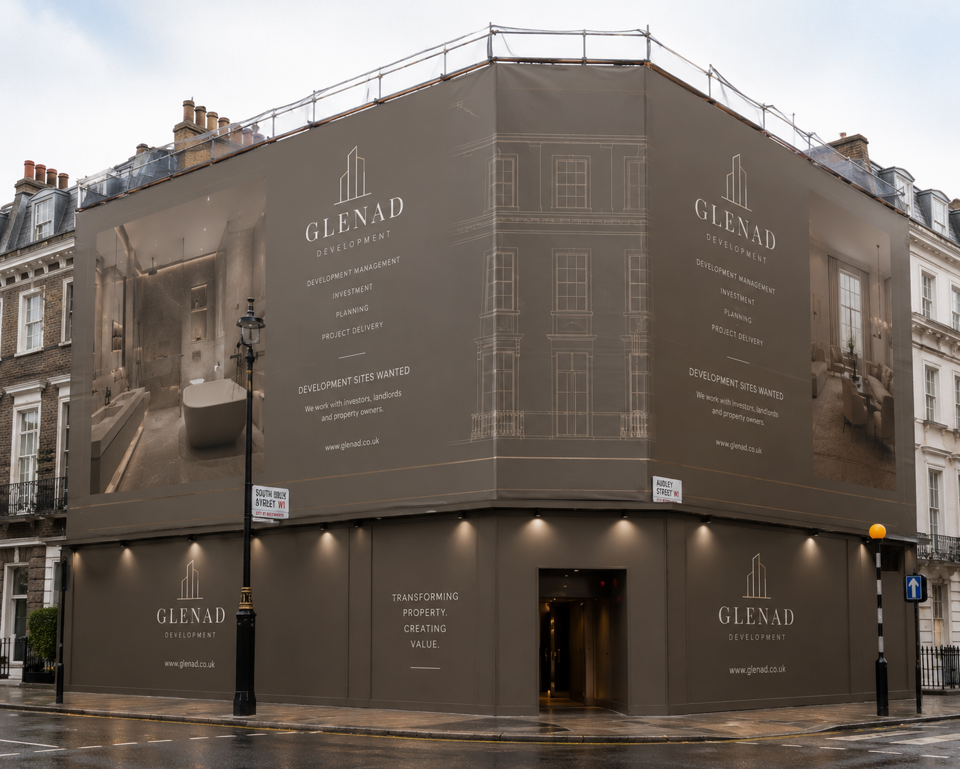 Building covered with large banners promoting Glenad Development, featuring interior images, architectural drawings, and text about development services like management, investment, planning, and project delivery.