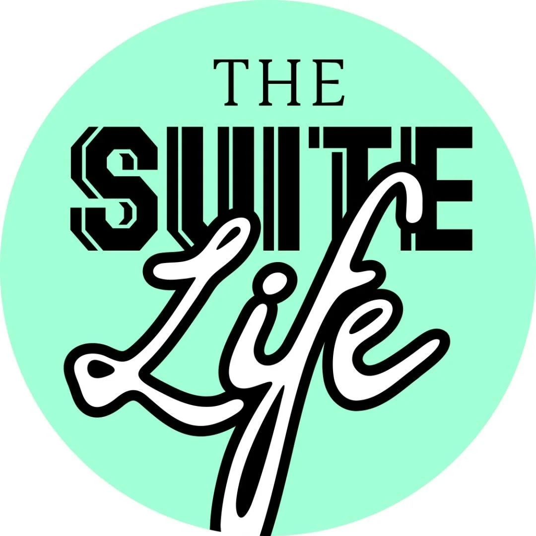 Circle with mint green background containing the text "The Suit Life" in a mix of bold, stylized fonts with "Sunset" in black outlined block letters and "Life" in cursive white font.