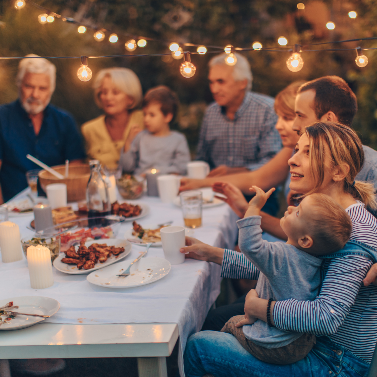 a multi-gen family having dinner in a vineyard in Italy