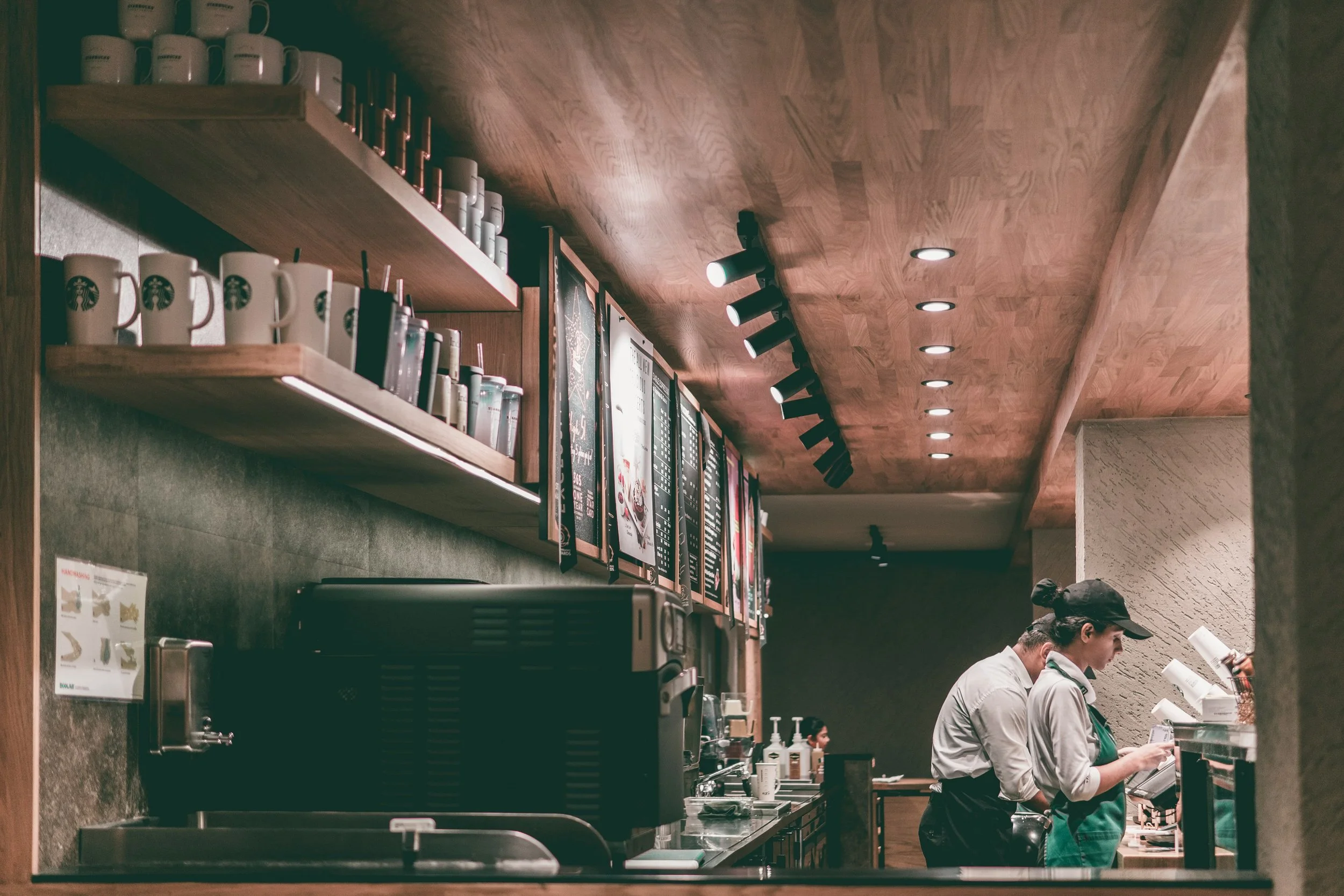 Starbucks baristas preparing coffees