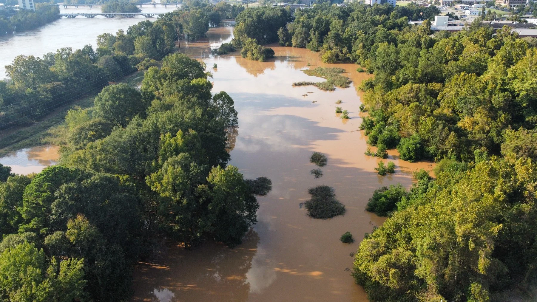 Aerial view of flooding along a river corridor and adjacent low-lying land in Columbia, South Carolina.
