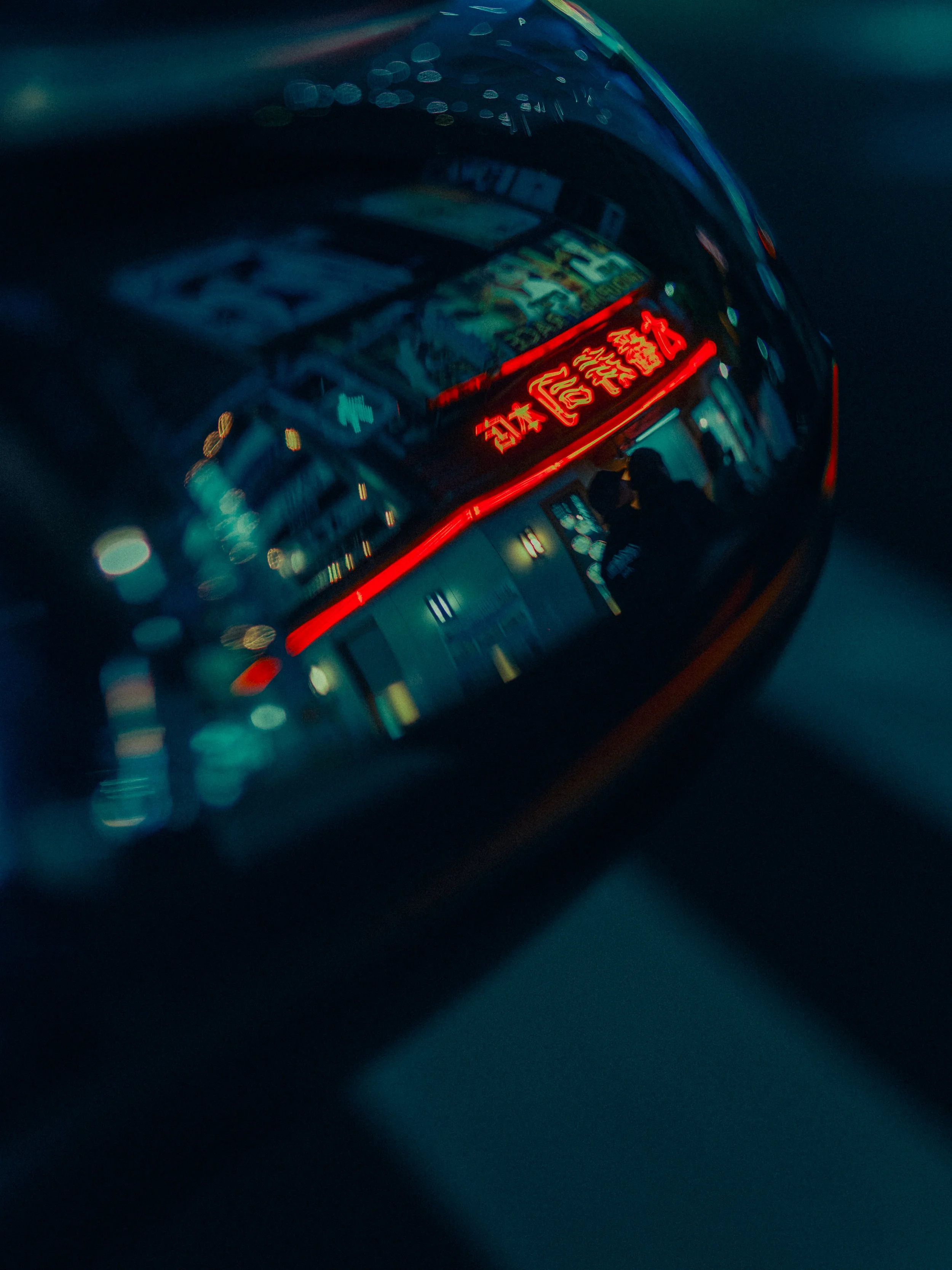Close-up of a digital clock displaying the time 8:24, with bright red LED numbers against a dark background, reflected on a curved, shiny surface.