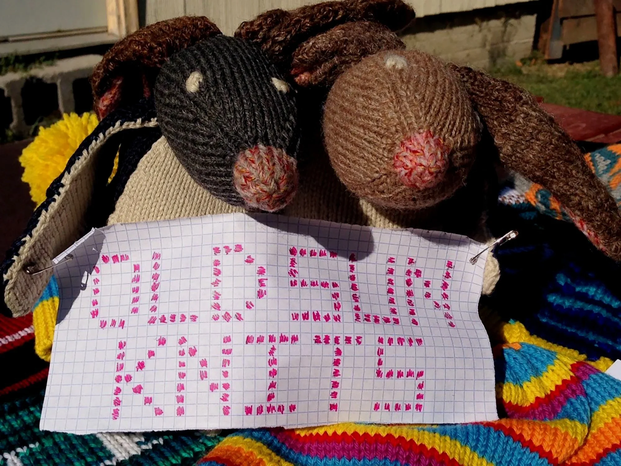 Hand-knit stuffed animals with an Old Sun Knits sign