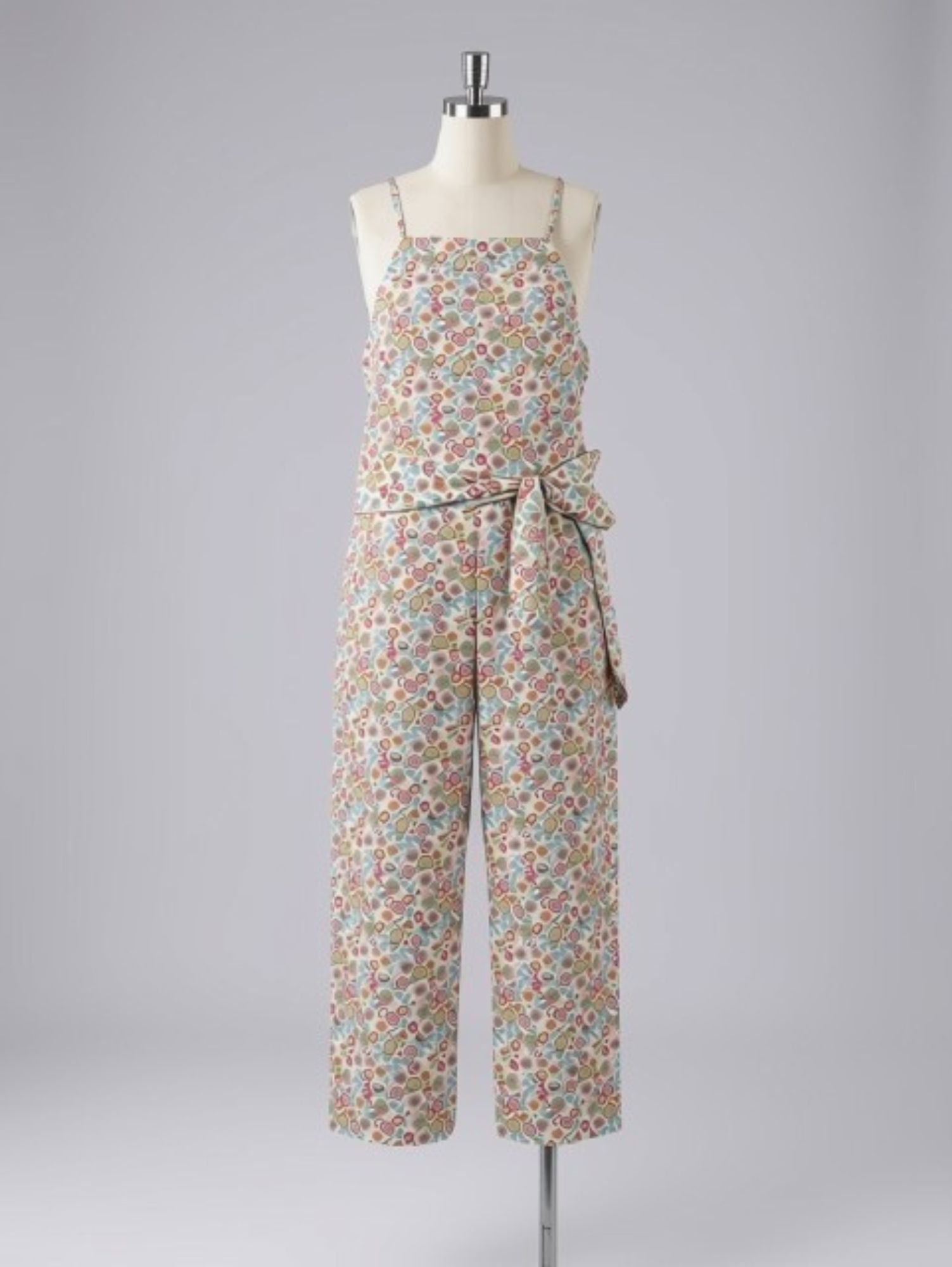 Colorful floral print sleeveless dress on a mannequin with a tied bow at the waist, displayed against a plain background.