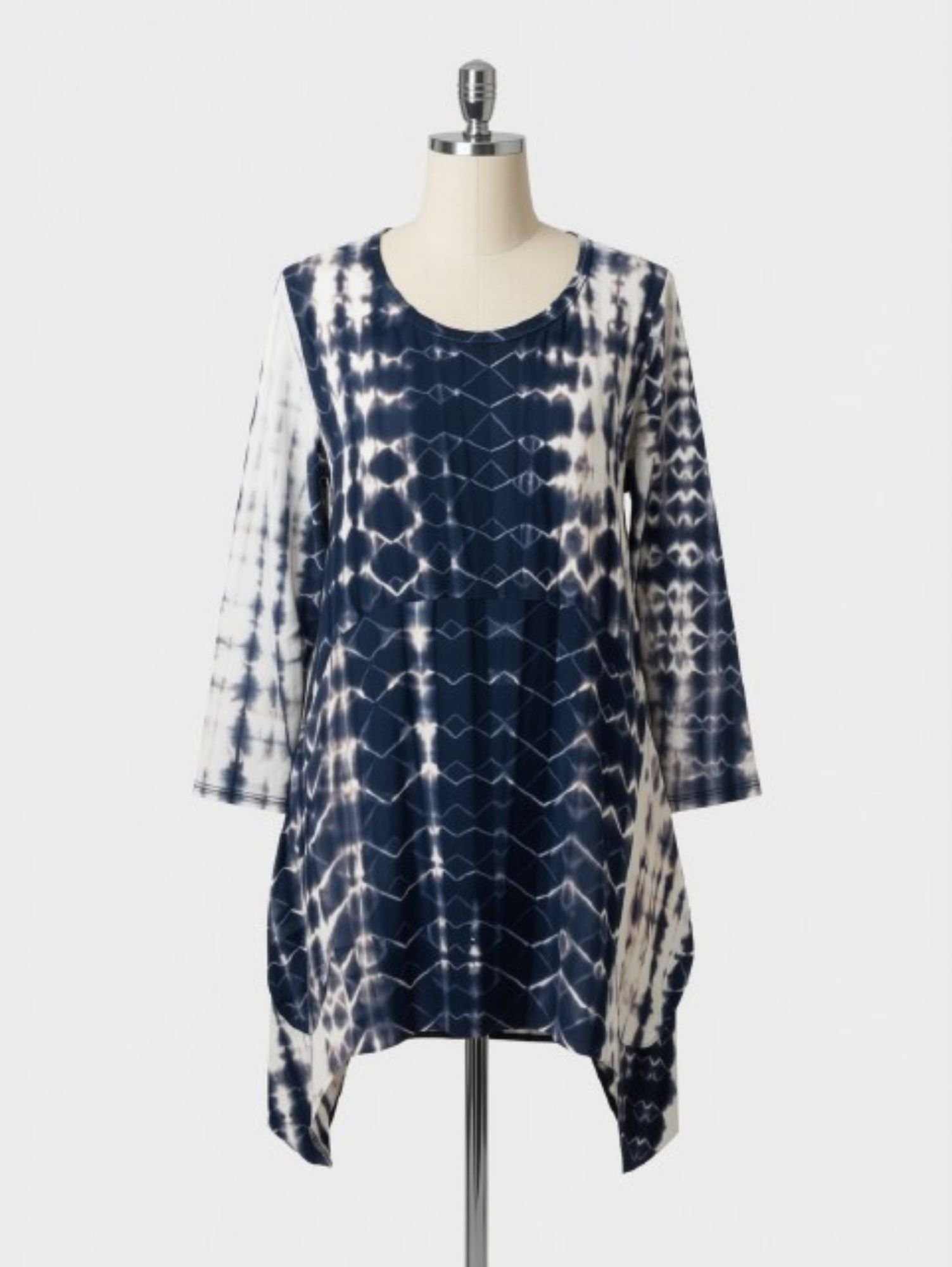 Blue and white tie-dye long-sleeve dress on a mannequin with a silver stand and neck piece