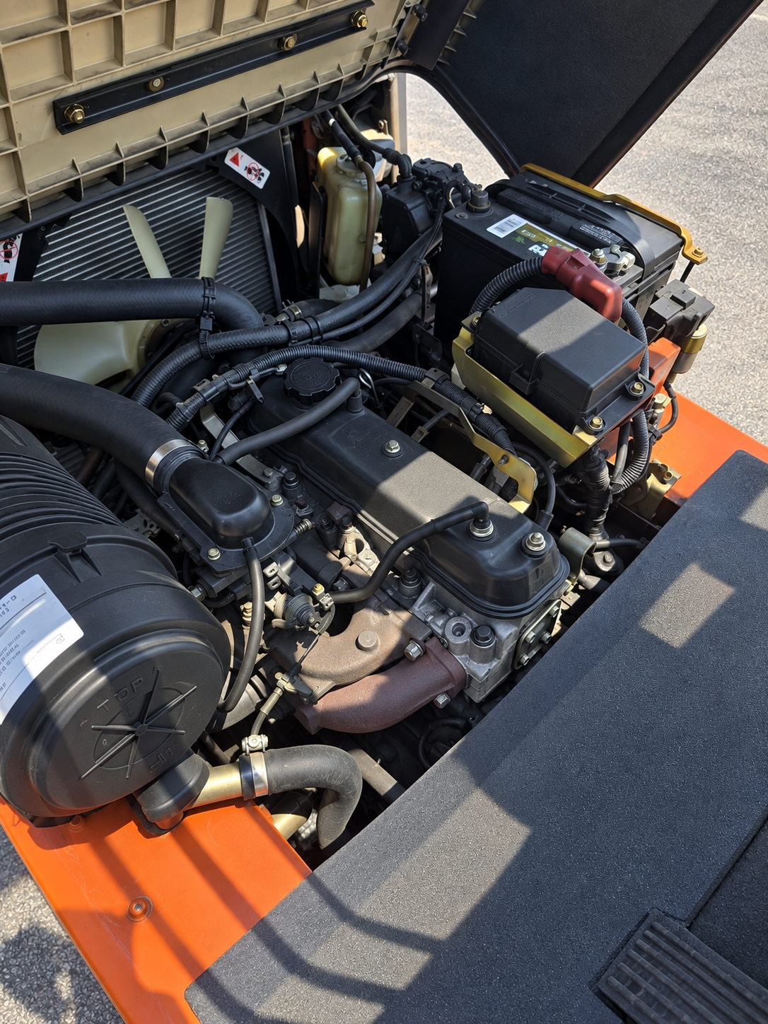 Toyota forklift repair close-up photo of engine work/ battery replacement.