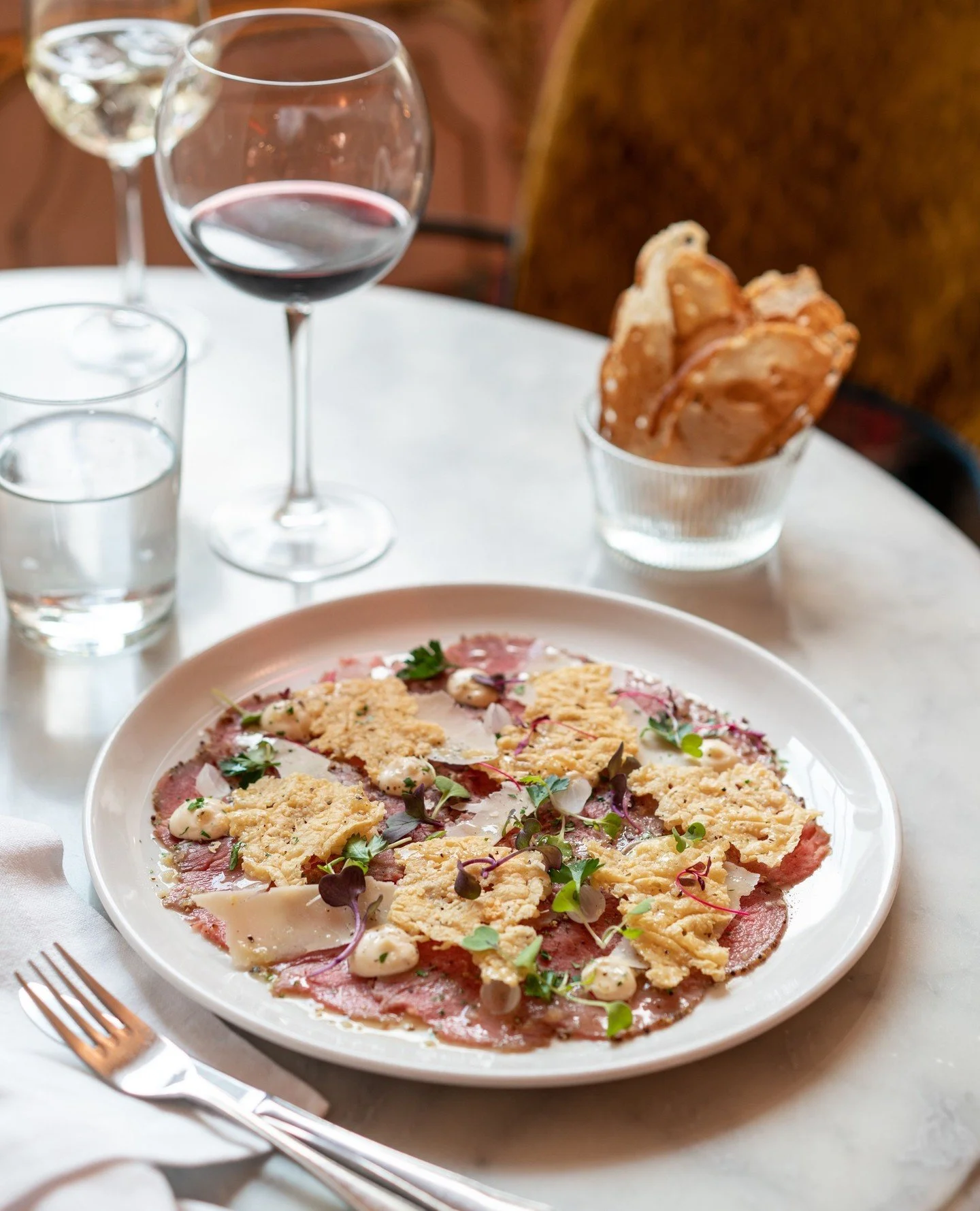 Beef Carpaccio. Mustard-cured beef tenderloin, truffle mayo, pickled onion, parmesan hard cheese crisps and shavings, lemon vinaigrette, micro herbs, chopped parsley, melba toast .⁠
⁠
#beefcarpaccio #frenchbistro #leparc ⁠