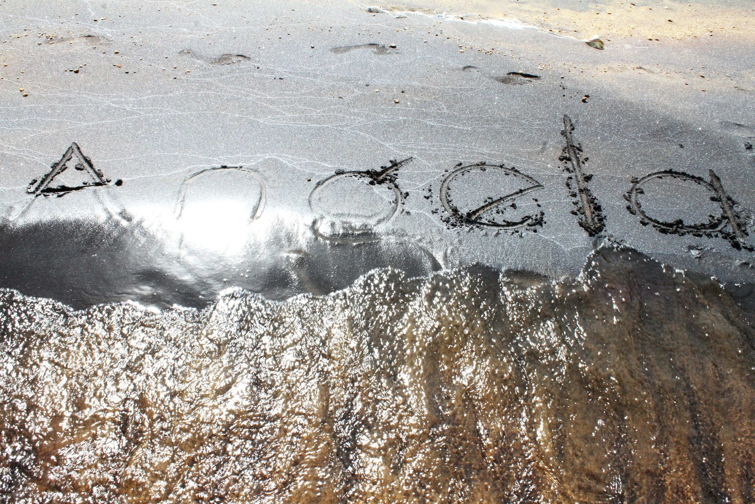 "My first visit to Lake Malawi was in 2018.  I documented as the waves washed away  my name written in the sand. It reminded me of my momentary belonging." © Angela Jimu