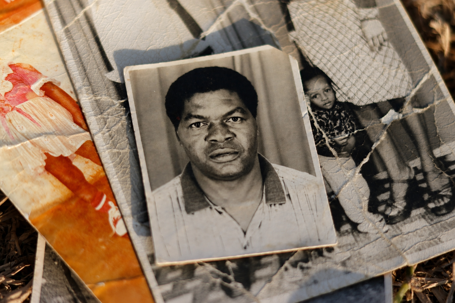 A collection of old, worn out photographs in Tendai's archives where in some cases, it is difficult to make out the faces.© Angela Jimu