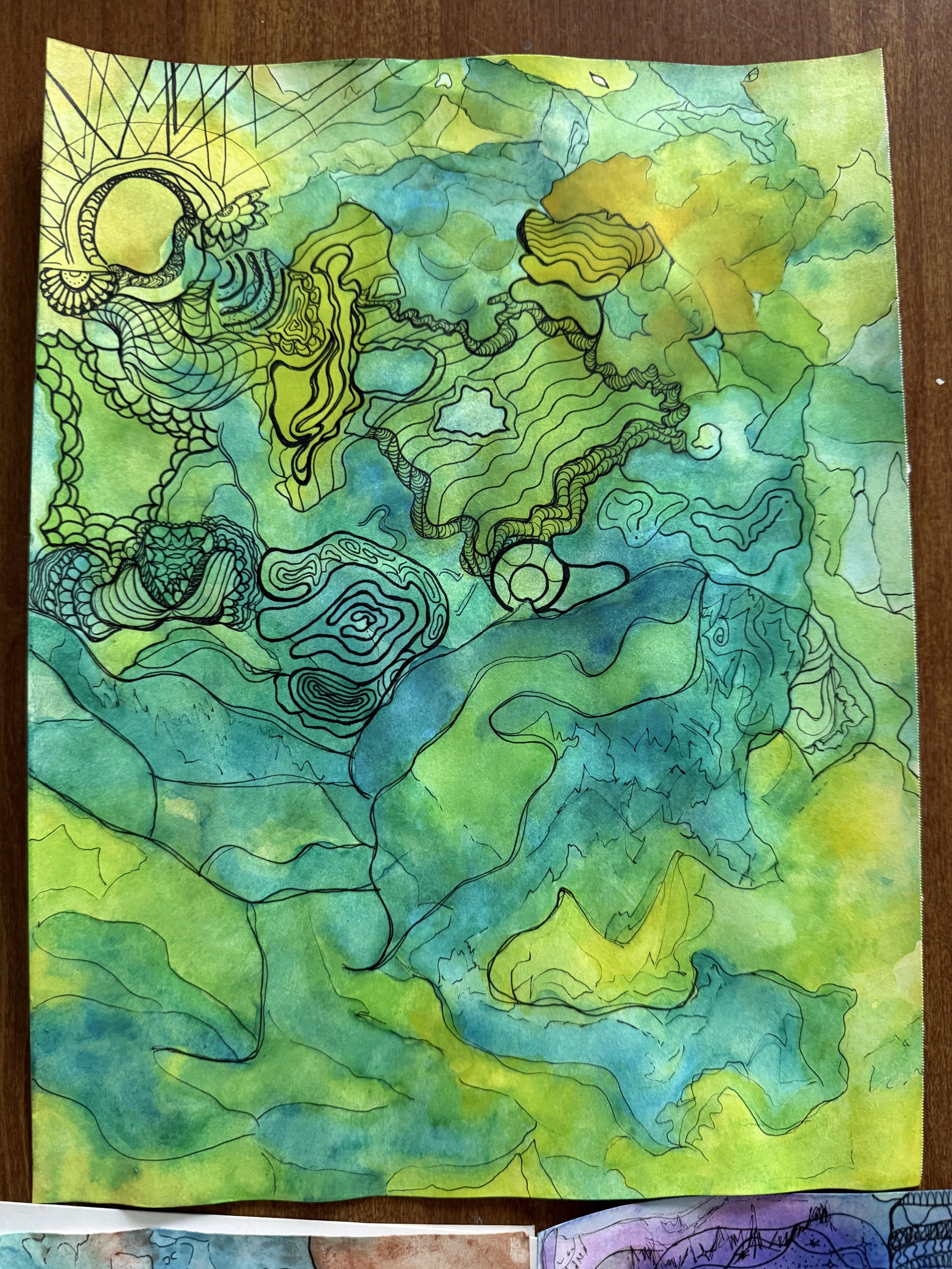 A close view of green, turquoise, and yellow watercolor with organic linework.