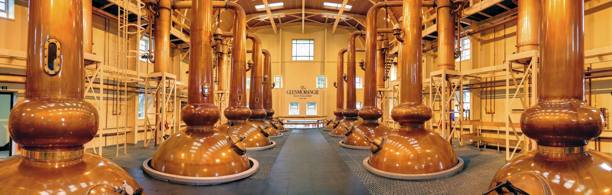 Interior of Glenmorangie Distillery with large copper stills.