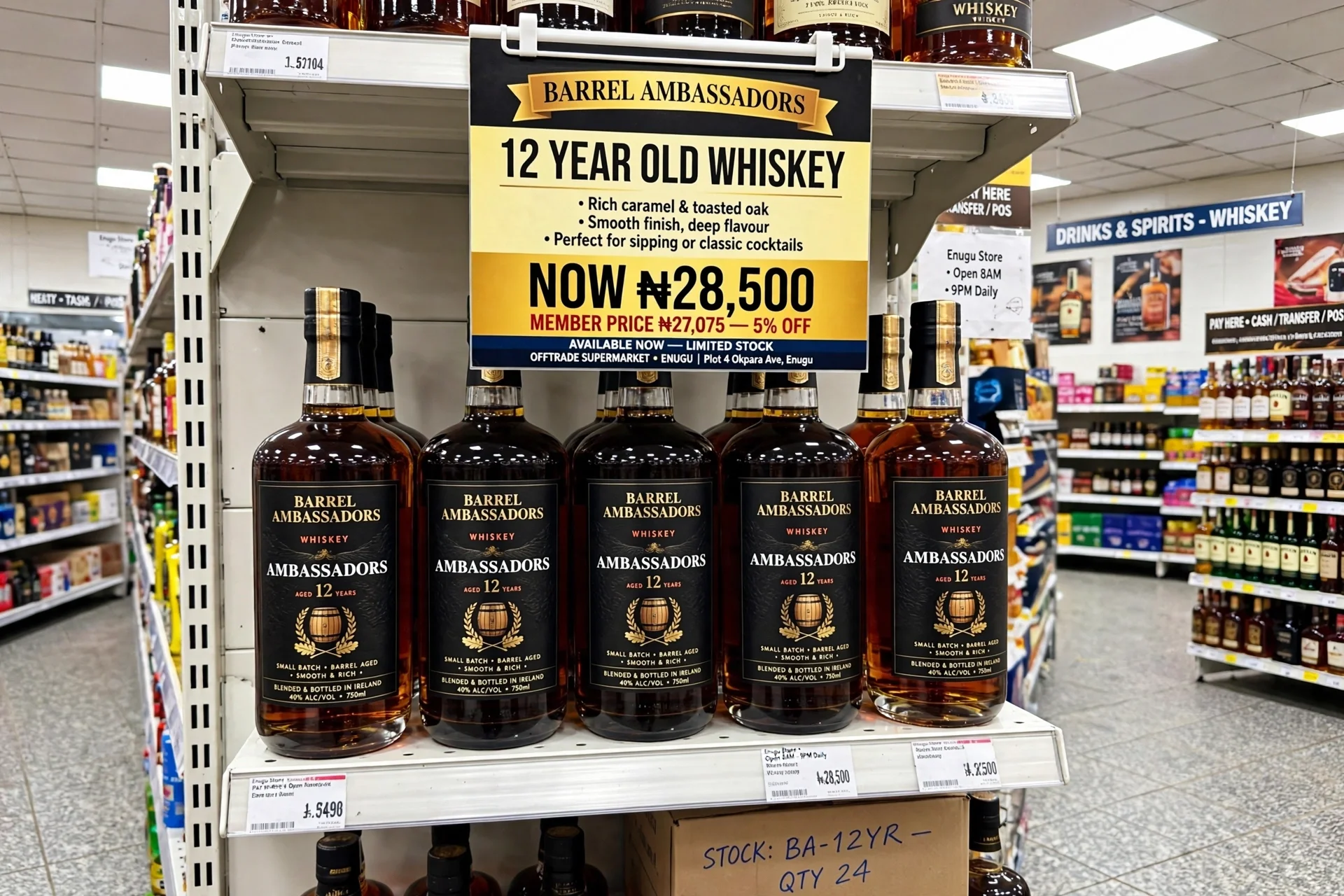 Shelf display of Barrel Ambassadors 12-year-old whiskey bottles in a supermarket. The label promotes rich caramel and toasted oak flavors, a smooth finish, and suitable for sipping or cocktails. The price tag shows 28,500 Naira, with a member price of 27,075 Naira for a limited stock of 24 bottles.