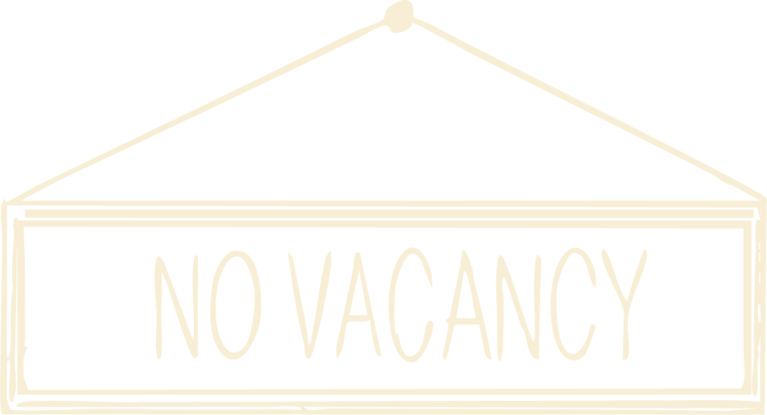 Sign hanging on a string with the words 'NO VACANCY' written on it.