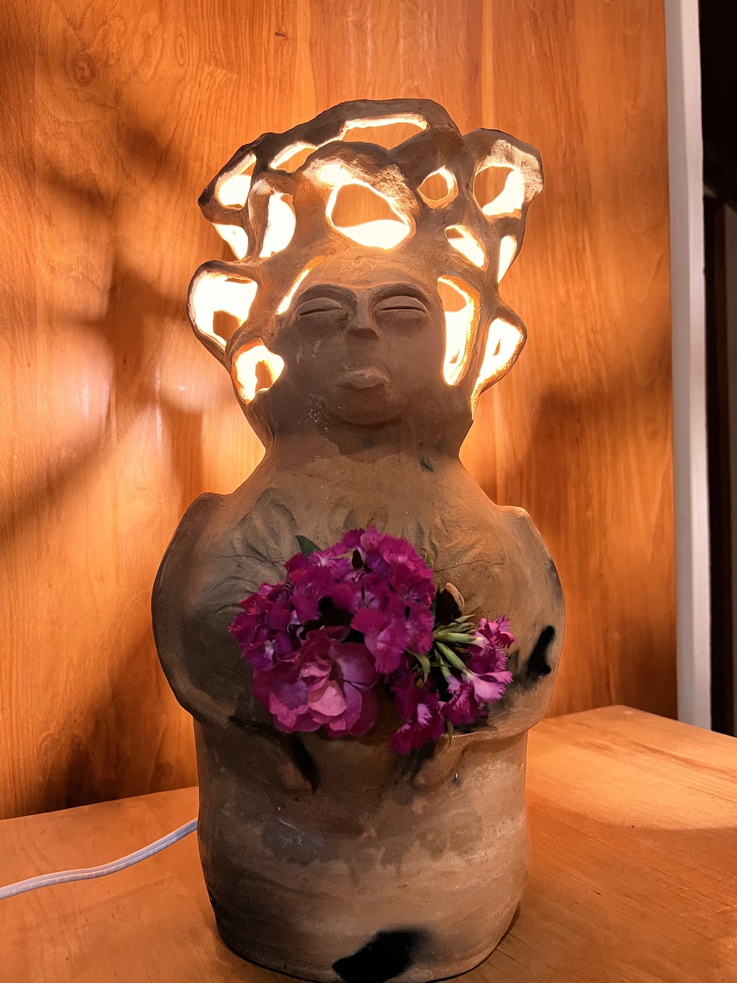 Lamp with a female face and arms holding flowers made from Amatenango clay