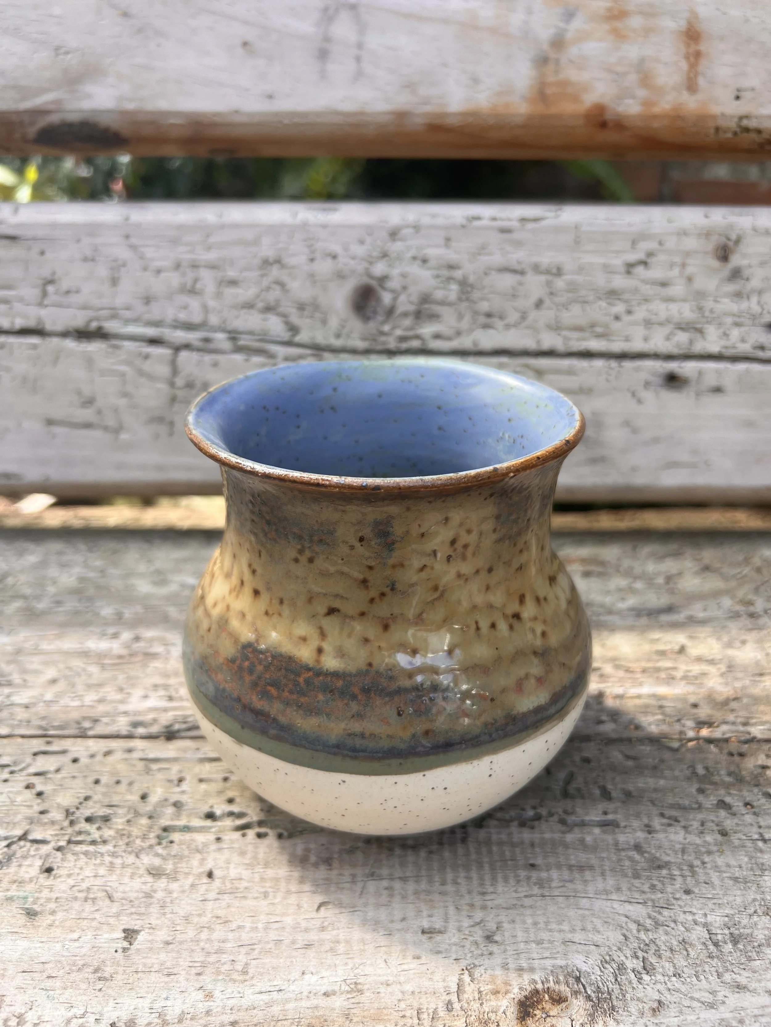 High-fired vase with speckled finish on the outside and matte blue on the inside.