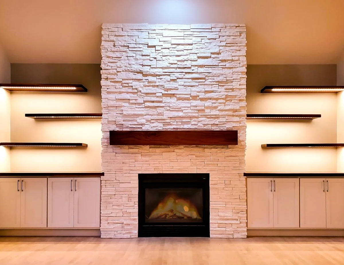 Custom stone fireplace installation completed by F&M Construction & Remodeling on Mercer Island, WA, featuring built-in cabinetry, floating shelves, and luxury living room remodeling serving Bellevue, Seattle, and the Eastside.