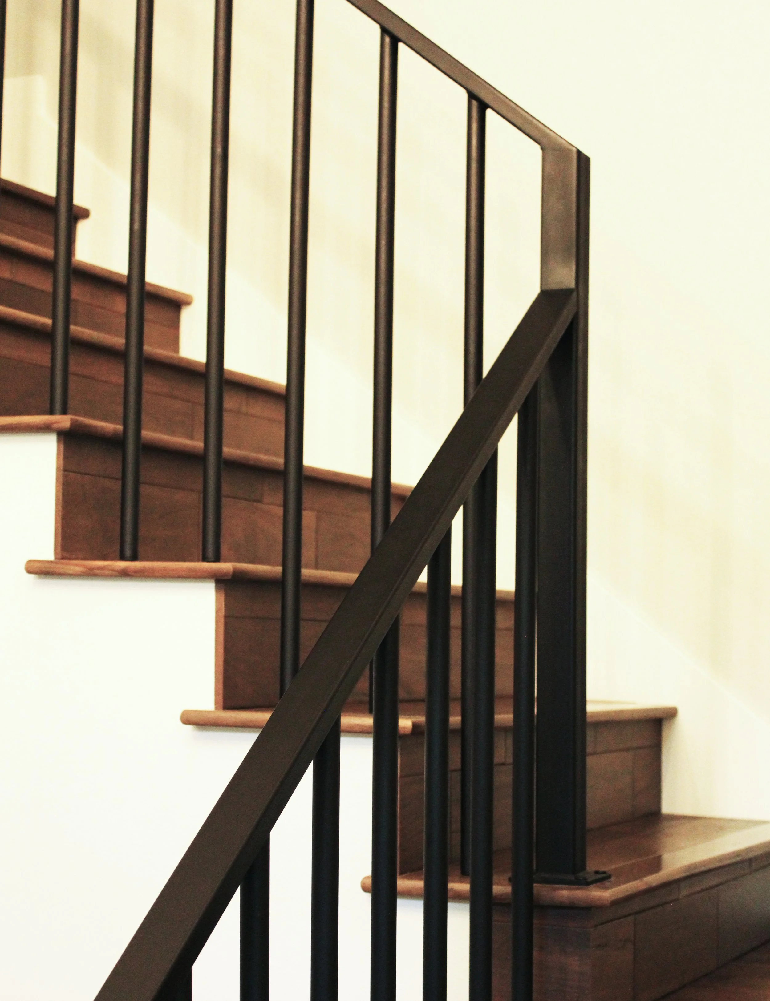 Hardwood stairs with custom metal railings by F&M Construction & Remodeling in Kirkland, WA, serving Bellevue, Seattle, and the Eastside.